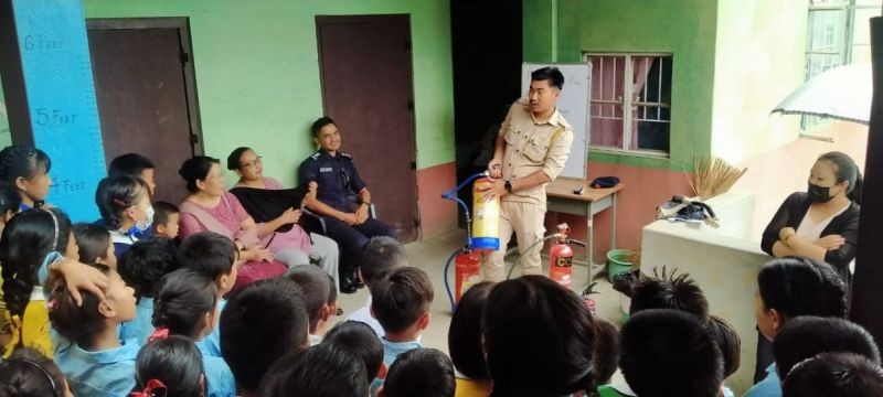 A personnel carrying out a mock drill and awareness on fire safety and rescue technique at Government Primary School, Lerie for Children with Special Needs on May 31. (Morung Photo)